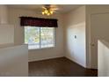Cozy bedroom with wood-look tile floors, a large window, and a ceiling fan at 698 S Racetrack Rd # 1411, Henderson, NV 89015