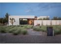 Contemporary home with modern landscape and stone pathway at 7030 Schirlls St, Las Vegas, NV 89118
