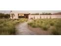Landscaped front yard with a stone pathway leading to the entrance at 7030 Schirlls St, Las Vegas, NV 89118