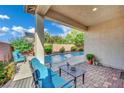 Covered patio features outdoor seating and a view of the pool and desert landscaping at 708 Kibbey St, Las Vegas, NV 89178