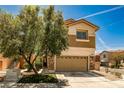 Two-story home featuring a two car garage, neutral color palette, and stone accents on exterior at 7083 Somera Way, Las Vegas, NV 89113