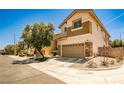 Two-story home featuring a two car garage, neutral color palette, and stone accents on exterior at 7083 Somera Way, Las Vegas, NV 89113
