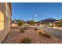 View of neighborhood landscaping with decorative rock, shrubs and trees at 722 Descartes Ave, Henderson, NV 89002