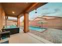 Inviting backyard oasis featuring a cozy patio, outdoor furniture, and a sparkling in-ground pool at 7235 Summer Air Ave, Las Vegas, NV 89179