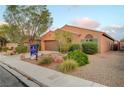 Attractive single-story home featuring desert landscaping, a two-car garage, and a paved driveway at 7235 Summer Air Ave, Las Vegas, NV 89179