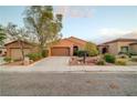 Inviting single-story home with desert landscaping, a two-car garage, and a welcoming front entrance at 7235 Summer Air Ave, Las Vegas, NV 89179