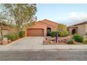 Beautiful single-story home showcasing desert landscaping, a two-car garage, and a pleasant facade at 7235 Summer Air Ave, Las Vegas, NV 89179