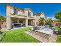 Expansive backyard with manicured lawn, patio, and raised hot tub perfect for outdoor entertaining at 7424 Rainford St, Las Vegas, NV 89148