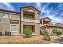 View of the condo complex featuring private balconies, red tile roof, and well-kept landscaping at 75 N Valle Verde Dr # 211, Henderson, NV 89074