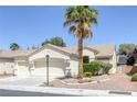 Inviting single-story home featuring a three-car garage and desert landscaping at 7544 Coral River Dr, Las Vegas, NV 89131