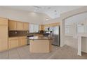 Bright kitchen featuring stainless steel appliances, granite counters, and a center island at 7544 Coral River Dr, Las Vegas, NV 89131