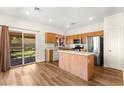 Bright kitchen featuring an island, stainless steel appliances, and sliding door to backyard at 8113 Danaides Ct, Las Vegas, NV 89131
