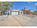 Charming home featuring a two-car garage and long driveway at 823 Spikenard Dr, Henderson, NV 89002