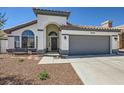 Attractive single-story home with a well-manicured front yard, arched entry, and two-car garage at 8309 Windrush Ave, Las Vegas, NV 89117