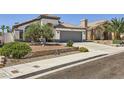 Lovely one-story home with desert landscaping, two car garage, and beautiful curb appeal at 8309 Windrush Ave, Las Vegas, NV 89117
