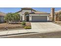 Inviting single-story house with a concrete driveway, desert landscaping, and attached two-car garage at 8309 Windrush Ave, Las Vegas, NV 89117
