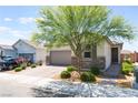 Inviting single-story home with landscaped front yard, desert foliage, and brick accents at 8351 Vinamala Ave, Las Vegas, NV 89149