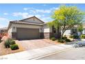 Attractive one-story home featuring a two-car garage and desert landscaping at 8351 Vinamala Ave, Las Vegas, NV 89149