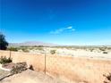 Expansive backyard with desert landscaping and mountain views beyond the brick fence at 8616 Willow Cabin St, Las Vegas, NV 89131