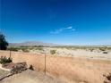 Mountain views from backyard featuring desert landscaping and a brick privacy wall at 8616 Willow Cabin St, Las Vegas, NV 89131