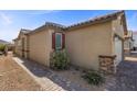 Exterior angle of home showcasing desert landscaping, walkway, and neutral tones at 10431 Seelos St, Las Vegas, NV 89178