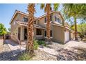 Two-story home featuring a tile roof, desert landscaping, and a covered porch entry at 10902 Pentland Downs St, Las Vegas, NV 89141