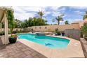 Inviting swimming pool and spa area surrounded by lush landscaping, perfect for outdoor relaxation at 1413 Gentle Brook St, North Las Vegas, NV 89084