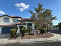 Beautiful two-story home with well-maintained landscaping and a large front yard on a sunny day at 1511 Balsam Mist Ave, Las Vegas, NV 89183