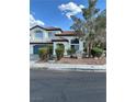 Beautiful two-story home featuring a tile roof, manicured landscaping, and a spacious two-car garage, offering great curb appeal at 1511 Balsam Mist Ave, Las Vegas, NV 89183