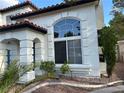 Close up of home's architecture showing stucco detailing, large windows and lovely front yard landscaping at 1511 Balsam Mist Ave, Las Vegas, NV 89183