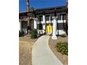 Inviting entrance featuring bright yellow double doors and manicured landscaping at 1871 Ski Slope Cir, Las Vegas, NV 89117