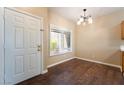 Inviting entryway with beautiful wood floors, white door, and natural light at 2152 Jasper Bluff St # 103, Las Vegas, NV 89117