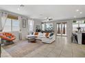 Bright living room with tile flooring, large windows, stylish furnishings, and access to dining area at 2169 Rio Rancho Pointe Pl, Henderson, NV 89002