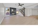Spacious living room with fireplace, light wood floors and a view to the backyard at 2402 El Cid Ct, Henderson, NV 89014