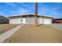 Charming single-story home featuring a unique patterned privacy screen, gravel landscaping, and a one-car garage at 2496 Golfers St, Las Vegas, NV 89142