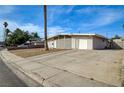 A single-story home displays gravel landscaping, an open driveway, and a quaint neighborhood street view at 2496 Golfers St, Las Vegas, NV 89142