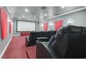 Enjoy movie nights in this home theater room with plush seating and a large screen at 2555 Antique Blossom Ave, Henderson, NV 89052