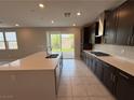 Beautiful kitchen with an island, stainless steel appliances, a gas cooktop, and backyard access at 2620 Tolmezzo St, Henderson, NV 89044