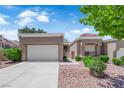 Charming single-story home with a two-car garage, manicured landscaping, and a well-maintained front yard at 2701 Glencliff Dr, Las Vegas, NV 89134