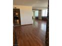 Open-concept living room with hardwood flooring and kitchen access at 3930 University Center Dr # 612, Las Vegas, NV 89119