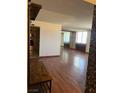 Open-concept living room with hardwood flooring and kitchen access at 3930 University Center Dr # 612, Las Vegas, NV 89119