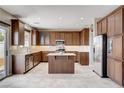 Bright kitchen featuring an island, wood cabinets and stainless steel appliances at 405 Prairie Moon Ave, North Las Vegas, NV 89084