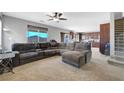 Comfortable living room featuring plush carpeting, a large sectional sofa, and an open floor plan at 405 Prairie Moon Ave, North Las Vegas, NV 89084
