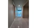 Inviting hallway featuring sleek tile flooring, neutral paint, and doors leading to various rooms with cityscape views beyond at 4525 Dean Martin Dr # 1507, Las Vegas, NV 89103