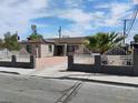 Attractive single-story home with light brown siding, gated yard and desert landscaping at 4525 Fulton Pl, Las Vegas, NV 89107