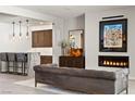 Stylish living room showcases fireplace, modern furnishings, and bar area at 47 Garibaldi Way, Henderson, NV 89011