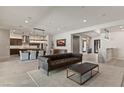 Open-concept living space with bar, dining area, and seamless flow into kitchen at 47 Garibaldi Way, Henderson, NV 89011