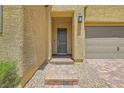 Inviting front entrance with a stylish door, brick steps and desert landscaping at 498 Pebble Run Ave, Henderson, NV 89011