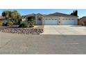 Beautiful one-story home with desert landscaping and a long driveway at 5451 Fernwood Ct, Pahrump, NV 89061