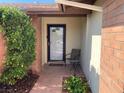Inviting front entrance with a decorative glass door, accent chair, and mature landscaping at 5821 Santa Catalina Ave, Las Vegas, NV 89108